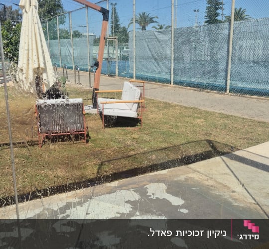 שטיפה וניקוי של ויטרינת זכוכית גדולה במתחם חוץ